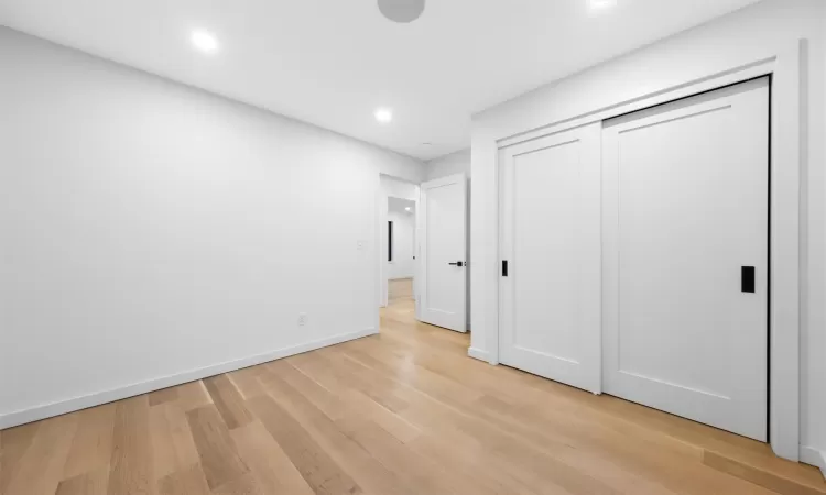 Unfurnished bedroom featuring a closet and light hardwood / wood-style flooring