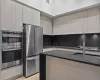 Kitchen featuring light hardwood / wood-style floors, light brown cabinetry, and appliances with stainless steel finishes