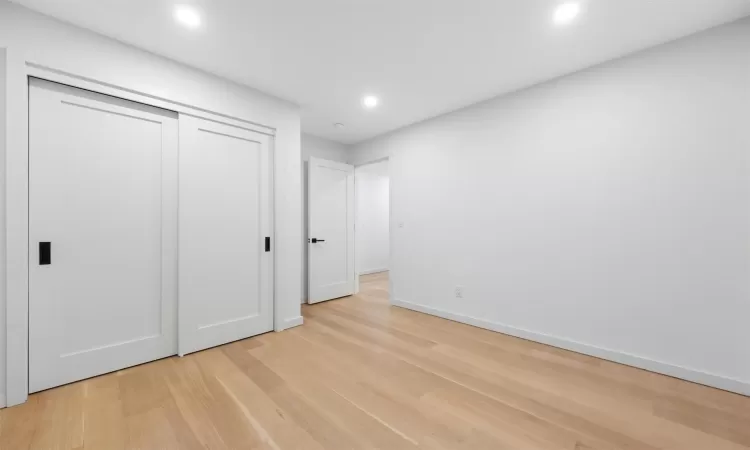 Unfurnished bedroom featuring light hardwood / wood-style floors and a closet