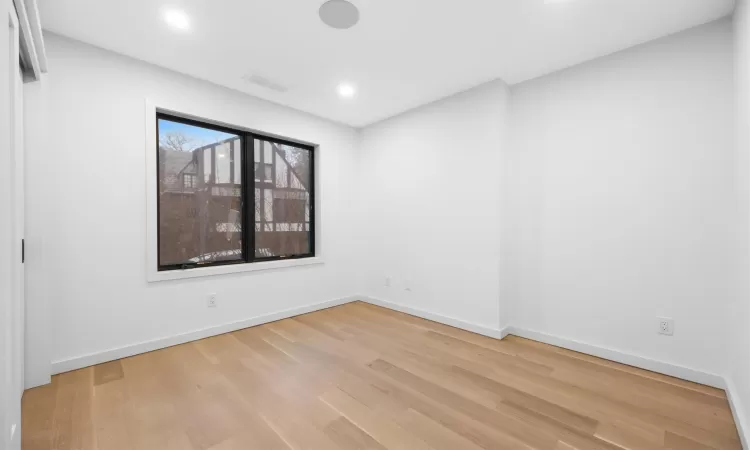 Empty room with light hardwood / wood-style flooring