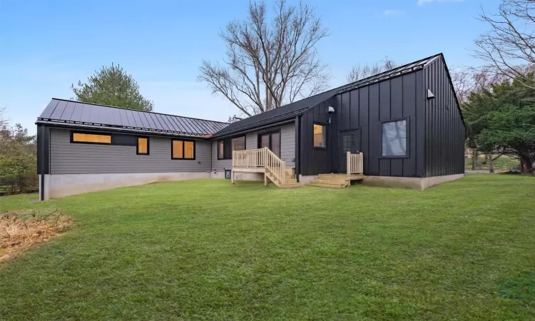 Rear view of property featuring a yard