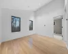 Unfurnished room featuring light hardwood / wood-style floors and lofted ceiling