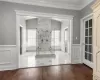 Bathroom with an enclosed shower, toilet, ornamental molding, and wood-type flooring