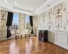 Sitting room with a tray ceiling, a wealth of natural light, crown molding, and hardwood / wood-style flooring