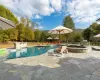 View of pool featuring a mountain view, a patio area, and an in ground hot tub