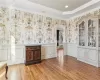 Bar featuring hardwood / wood-style flooring and ornamental molding