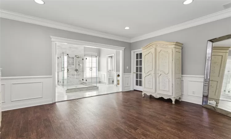 Entrance foyer with ornamental molding and dark wood-type flooring