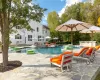 View of pool featuring a patio area and an in ground hot tub