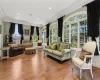 Living room featuring wood-type flooring and ornamental molding