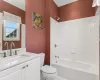 Full bathroom featuring shower / bathing tub combination, vanity, tile patterned flooring, toilet, and ornamental molding