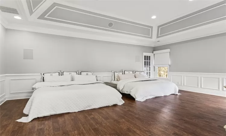 Bedroom with dark hardwood / wood-style floors and crown molding