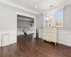 Bedroom featuring crown molding and dark hardwood / wood-style floors