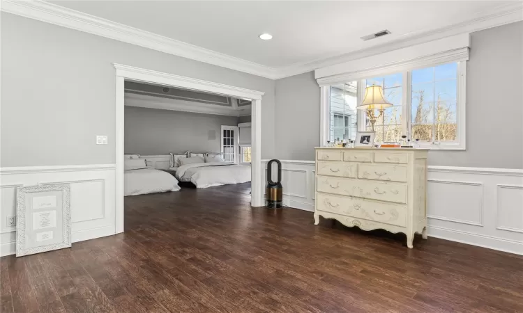 Bedroom featuring crown molding and dark hardwood / wood-style floors