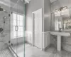 Bathroom with a wealth of natural light, a shower with door, and beamed ceiling