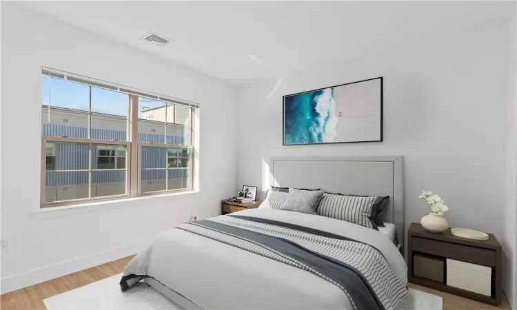 Staged Bedroom with hardwood / wood-style flooring