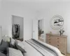 Staged Bedroom with wood-type flooring, a closet, and a spacious closet