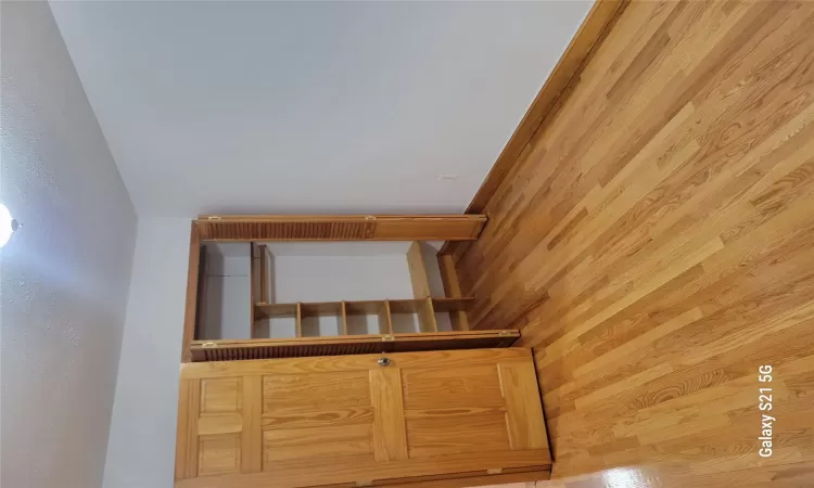 Unfurnished bedroom with a textured ceiling, light hardwood / wood-style flooring, and a closet