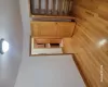 Unfurnished bedroom featuring a textured ceiling, light wood-type flooring, electric panel, and a closet