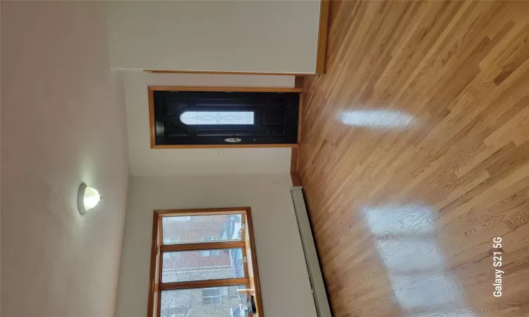 Entrance foyer featuring light hardwood / wood-style flooring and a baseboard heating unit