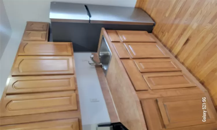 Kitchen with refrigerator, sink, light brown cabinets, and light hardwood / wood-style flooring