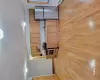 Kitchen with light wood-type flooring, sink, range, fridge, and range hood