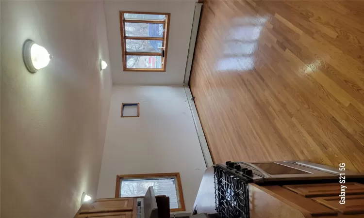 Kitchen with a healthy amount of sunlight, range, baseboard heating, and extractor fan