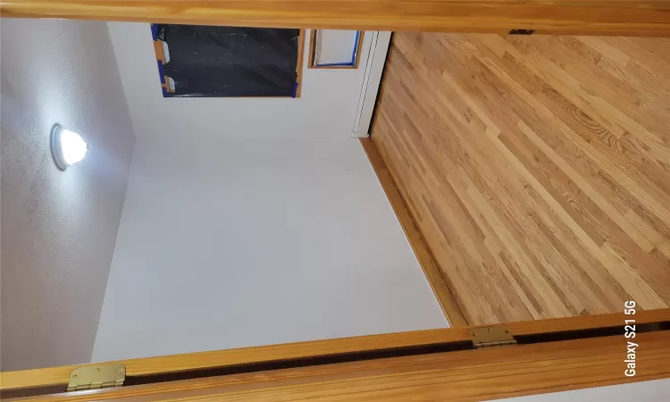 Spare room featuring a textured ceiling, light hardwood / wood-style flooring, and baseboard heating