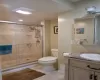 Bathroom with vanity, toilet, and a shower with door