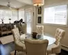 Dining space featuring baseboard heating, ceiling fan, and dark hardwood / wood-style flooring