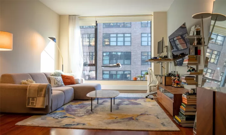 Sitting room with plenty of natural light and dark hardwood / wood-style floors