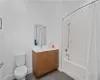 Full bathroom with vanity, tile patterned floors, toilet, and shower / tub combo