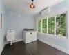 Laundry room featuring a wall mounted air conditioner, dark hardwood / wood-style floors, and separate washer and dryer