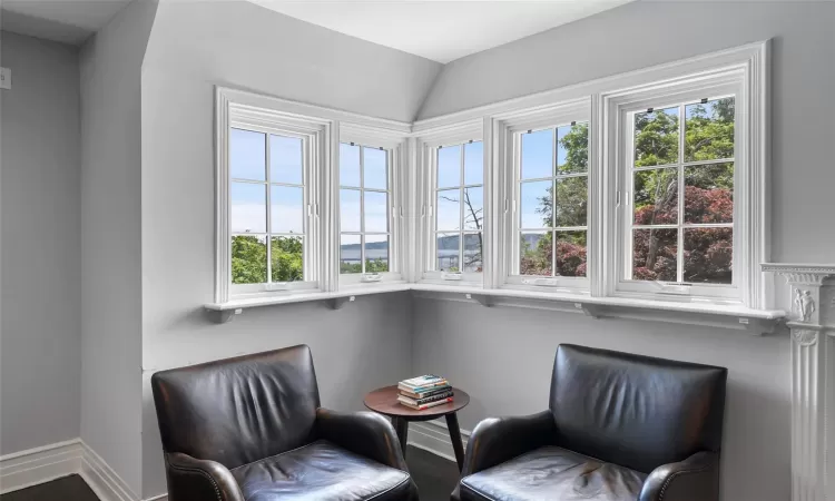 Sitting room featuring hardwood / wood-style floors and a healthy amount of sunlight