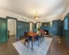 Dining room with dark hardwood / wood-style flooring and a wall mounted AC