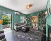 Living room featuring built in shelves, dark wood-type flooring, a wall unit AC, and ornamental molding