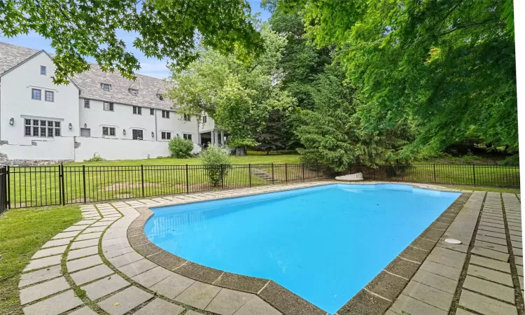 View of pool with a yard