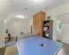 Playroom featuring lofted ceiling and dark wood-type flooring