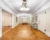 Corridor with crown molding and light parquet floors