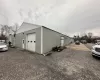 View of home's exterior with an outdoor structure and a garage