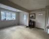 Carpeted entrance foyer featuring a textured ceiling