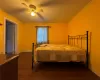 Bedroom featuring ceiling fan, dark hardwood / wood-style flooring, and ornamental molding