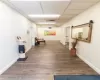 Hallway with a barn door, a drop ceiling, and wood-type flooring