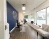 Office area with a drop ceiling and dark wood-type flooring