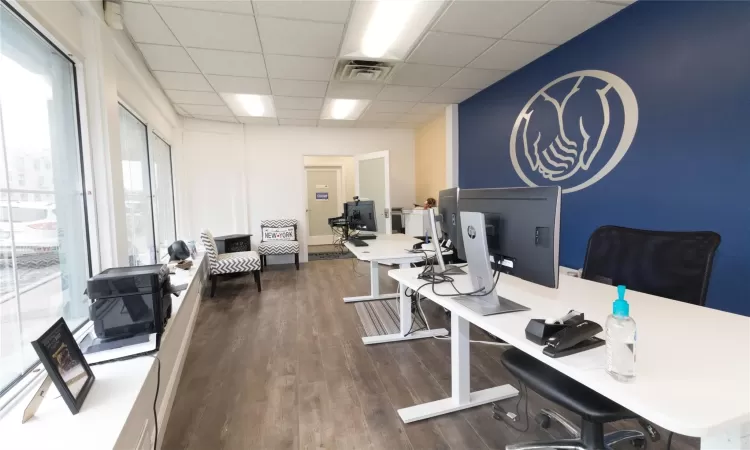 Office featuring a drop ceiling and dark hardwood / wood-style flooring