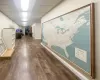 Corridor featuring a paneled ceiling and dark hardwood / wood-style flooring