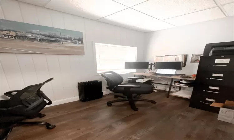 Office featuring a drop ceiling and dark hardwood / wood-style flooring