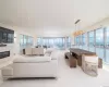 Living room with plenty of natural light and a chandelier