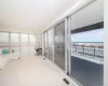 Sunroom / solarium featuring a beach view and a water view