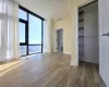 Unfurnished bedroom with hardwood / wood-style flooring and expansive windows