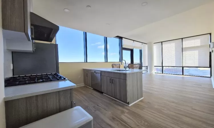 Kitchen featuring dark hardwood / wood-style flooring, refrigerator, exhaust hood, sink, and dishwasher